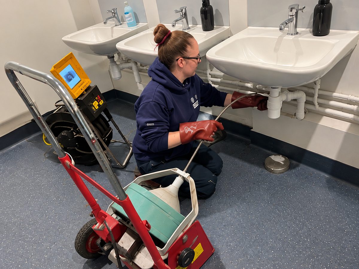 Drain engineer clearing commercial drainage in London